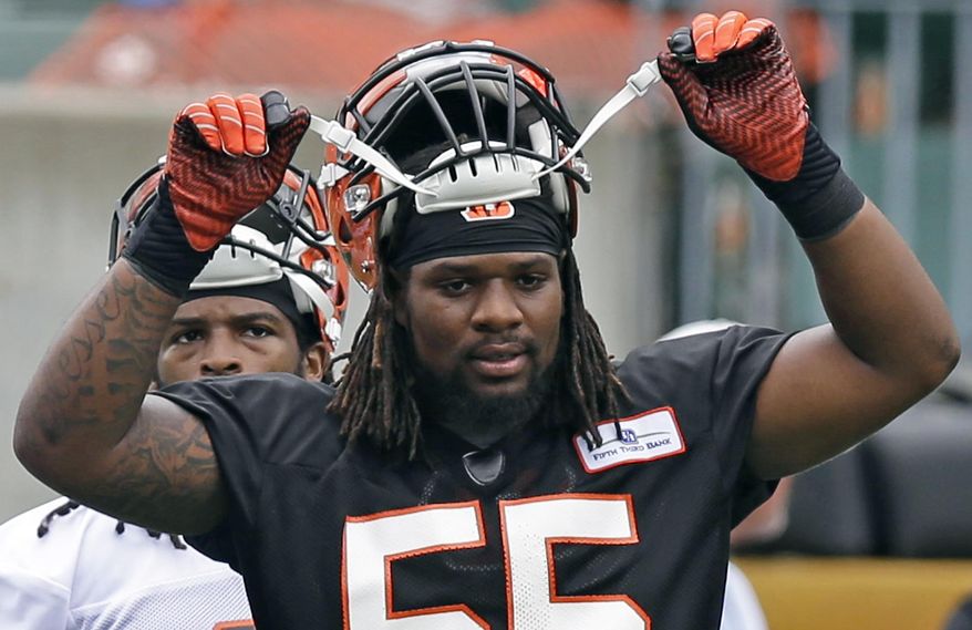FILE - In this June 10, 2014, file photo, Cincinnati Bengals outside linebacker Vontaze Burfict adjusts his helmet during an NFL football mandatory minicamp in Cincinnati. The Bengals think that they'll improve significantly with Burfict back at linebacker. They did last year in a similar situation. (AP Photo/File)