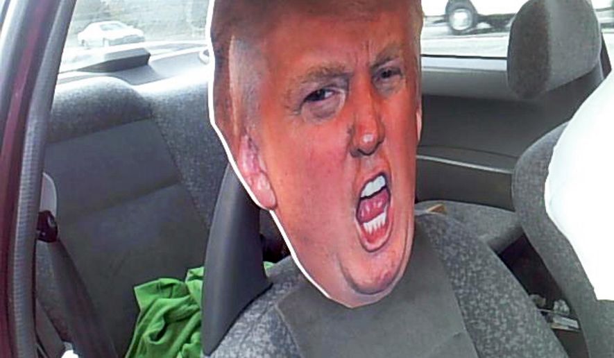 This photo provided by the Washington State Patrol shows a cardboard cutout of Republican presidential nominee Donald Trump's head in the passenger seat of a car Tuesday, Sept. 27, 2016, in Seattle. A trooper stopped the motorist who was driving with the cardboard likeness in a carpool lane south of Seattle on Highway 167. The stunt netted the driver a $136 ticket. (Washington State Patrol via AP)