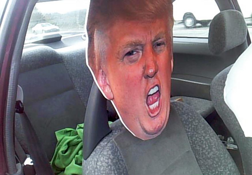 This photo provided by the Washington State Patrol shows a cardboard cutout of Republican presidential nominee Donald Trump's head in the passenger seat of a car Tuesday, Sept. 27, 2016, in Seattle. A trooper stopped the motorist who was driving with the cardboard likeness in a carpool lane south of Seattle on Highway 167. The stunt netted the driver a $136 ticket. (Washington State Patrol via AP)