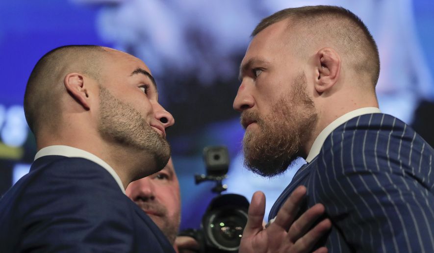 UFC lightweight champion Eddie Alvarez, left, and featherweight champion Connor McGregor, right, pose for photos during a new conference for UFC 205, Tuesday, Sept. 27, 2016, in New York. McGregor and Alvarez will headline the first UFC card to be held in the state since the state legislature legalized the sport earlier this year. UFC 205 is scheduled for Nov. 12. (AP Photo/Julie Jacobson)