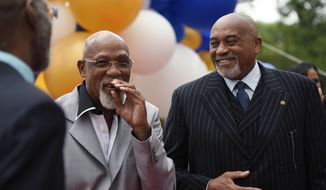 John Carlos, left, and Tommie Smith smile during an event in Washington on Wednesday, Sept. 28, 2016. Carlos and Smith voiced their support for Colin Kaepernick and other athletes staging national anthem protests, 48 years after they raised their gloved fists on the podium in a symbolic protest at the Olympics. (AP Photo/Sait Serkan Gurbuz)