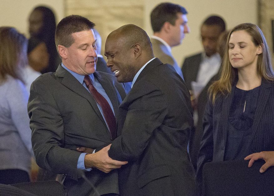 Oral "Nick" Hillary, center, hugs defense attorney Edward Narrow after being found not guilty in the murder of Garrett Phillips on Wednesday, Sept. 28, 2016, in Canton, N.Y. Hillary was accused of killing of his ex-girlfriend's 12-year-old son and was found not guilty by a judge. (Jason Hunter/Watertown Daily Times via AP, Pool)