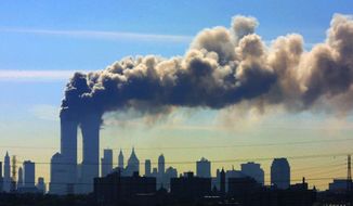 Smoke billows from the twin towers of the World Trade Center in New York after airplanes crashed into both towers, Sept. 11, 2001. (AP Photo/Gene Boyars) ** FILE **
