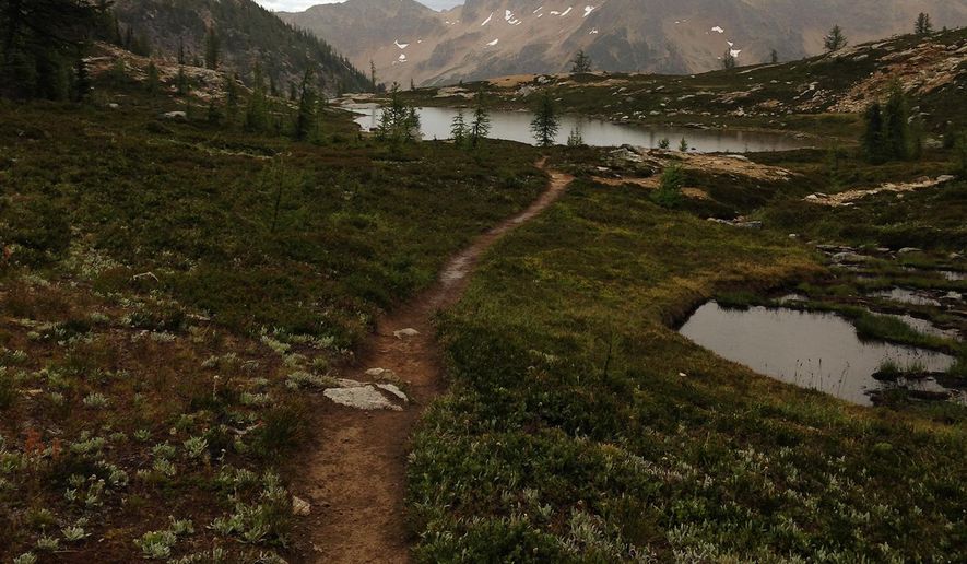 ADVANCE FOR SATURDAY, OCT. 1, 2016 AND THEREAFTER - In this August 2016 photo, a trail runs past the lower lake at Snowy Lakes, near the Pacific Crest Trail. Loerch hiked part of the Pacific Crest Trail alone. (Jessi Loerch/The Herald via AP)