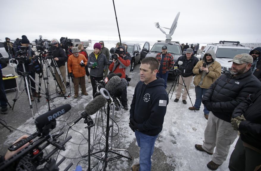 FILE - In this Jan. 9, 2016, Brandon Curtiss of the "Idaho 3%" group speaks to the media after arriving at the Malheur National Wildlife Refuge near Burns, Ore. More than 30 members of the "Idaho 3%" group say they've resigned after Curtiss, the group's president, spent $2,900 in donations on personal items rather than using it to help four Idaho men facing charges from a 2014 armed standoff with government agents in Nevada. The 36 members in mainly leadership positions of Idaho 3% announced the resignations Tuesday, Sept. 28, 2016. (AP Photo/Rick Bowmer, File)