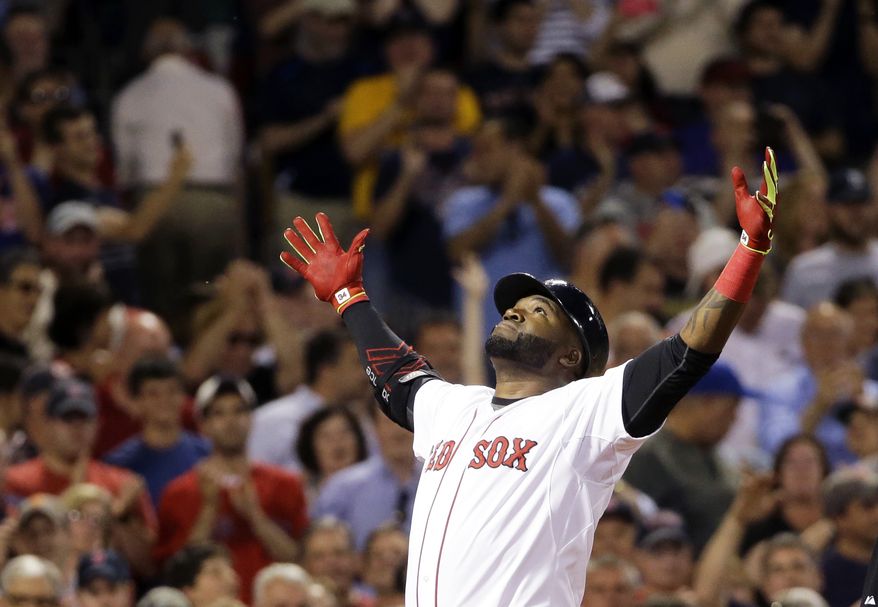 Boston Red Sox designated hitter David Ortiz reacts as he crosses home plate after hitting a two-run home run during the sixth inning of a baseball game against the Baltimore Orioles at Fenway Park in Boston, June 24, 2015. (Associated Press) ** FILE **