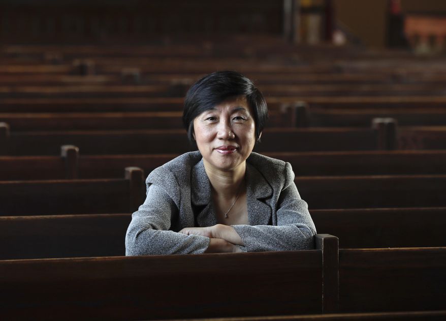In this Thursday, Sept. 8, 2016 photo, Superintendent Jie Zhang poses in a chapel at the New York Military Academy in Cornwall-on-Hudson, N.Y. While Republican presidential nominee, Donald Trump, talks tough about dealing with China, his old military prep school is building bridges to that country. The New York Military Academy began classes this fall with new Chinese backing and a former New York City high school principal originally from China in charge. (AP Photo/Mike Groll)