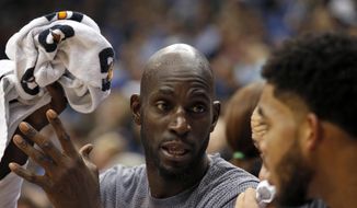FILE - In this Nov. 15, 2015, file photo, Minnesota Timberwolves forward Kevin Garnett, left, talks with Karl-Anthony Towns, right, during the second half of an NBA basketball game against the Memphis Grizzlies in Minneapolis. Cleveland Cavaliers coach Tyronn Lue says he’s got a coaching spot available on his staff for Kevin Garnett if the former NBA star wants it. A 15-time NBA All-Star, Garnett recently retired after 21 seasons. The 40-year-old Garnett and Lue are close friends. (AP Photo/Ann Heisenfelt, File)