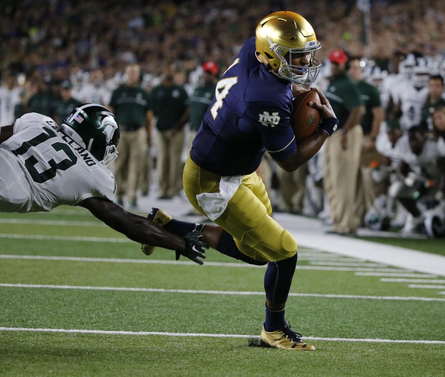 FILE - In this Sept. 17, 2016, file photo, Notre Dame quarterback DeShone Kizer (14) turns the corner past Michigan State cornerback Vayante Copeland (13) and heads to the end zone for a touchdown during the first half of an NCAA college football game against Michigan State in South Bend, Ind. At first glance, it seems a bit odd to hear Notre Dame coach Brian Kelly talk about how quarterback DeShone Kizer isn’t playing up to expectations.The 6-foot-4, 230-pound junior from Toledo, Ohio, is coming off a career-high for passing yards, throwing for 381 yards in a 38-35 loss to Duke, is on pace to break school records for passing efficiency (167.6) and for points responsible for per game (24) on an offense that is averaging 37.2 points a game, just below the school record of 37.6 points set in 1968. (AP Photo/Charles Rex Arbogast, File)