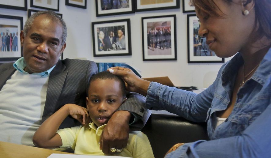 Raphael and Maribel Martinez comfort their son Andy after a press conference at their lawyer&#39;s office, Friday Sept. 30, 2016, in New York.  Maribel Martinez has filed a lawsuit against JetBlue Airways for mixing up Andy with another boy and flying him to the wrong city.  (AP Photo/Bebeto Matthews)