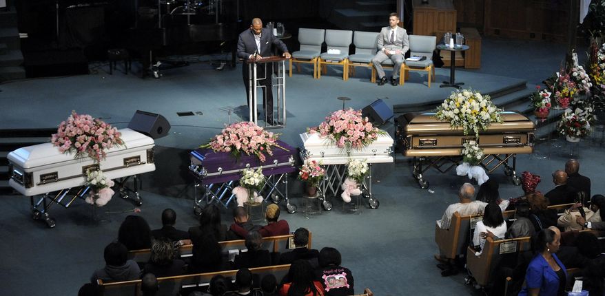 Family and loved ones pay their respects to four siblings who were allegedly killed in their Dearborn Heights home, by Gregory Green, a father to two of the children and a step-father to the two others, before their funeral service at Detroit First Church of the Nazarene in Farmington Hills, Mich., Friday Sept. 30, 2016. (Todd McInturf/Detroit News via AP)