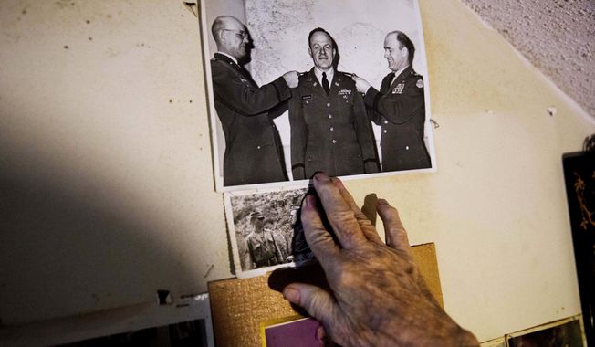 Memorabilia decorates a wall in the home of Frank Gleason, 96, a retired colonel with the Office of Strategic Services, in Atlanta, Wednesday, Sept. 28, 2016. Legislation to recognize the contributions of a group of World War II spies is hung up in Congress. Some 75 years ago, the OSS carried out missions behind enemy lines in Nazi Germany and the Pacific theatre. Gleason&#x27;s group was tasked with halting the Japanese advance into China. Gleason and his comrades did this by detonating bridges, railroad tracks and anything else. &#x27;We just blew stuff up left and right,&#x27; said Gleason. (AP Photo/David Goldman)
