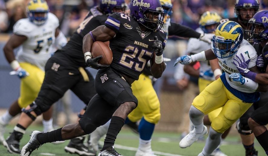 James Madison running back Cardon Johnson (25) moves the ball up the field during the first half of an NCAA football game against Delaware in Harrisonburg, Va., Saturday, Oct. 1, 2016. (Daniel Lin/Daily News-Record via AP)