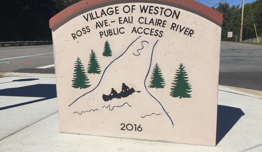 This Sept. 2016 photo shows the Ross Avenue bridge launch location marker in Eau Claire, Wis. The Ross Avenue launch site was started last fall and completed early this summer. The project cost almost $170,000 and includes a launch that is resistant to sediment, a bathroom, signs to help paddlers find their way, benches and tables and a water fountain. (Laura Schulte/The Wausau Daily Herald via AP)