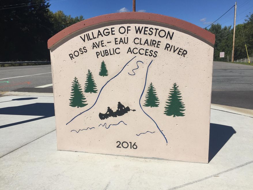 This Sept. 2016 photo shows the Ross Avenue bridge launch location marker in Eau Claire, Wis. The Ross Avenue launch site was started last fall and completed early this summer. The project cost almost $170,000 and includes a launch that is resistant to sediment, a bathroom, signs to help paddlers find their way, benches and tables and a water fountain. (Laura Schulte/The Wausau Daily Herald via AP)