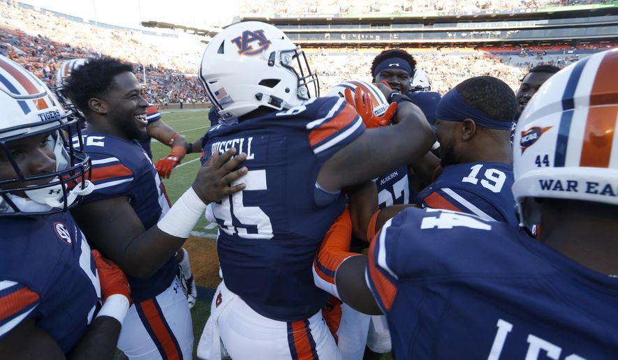 Auburn players mob Auburn defensive lineman Gary Walker (97) in the final seconds of the second half of Auburn's 58-7 win over Louisiana-Monroe in an NCAA college football game Saturday, Oct. 1, 2016 in Auburn, Al. Walker Sacked Louisiana-Monroe quarterback Garrett Smith in the end zone for a safety. (AP Photo/ Hal Yeager)