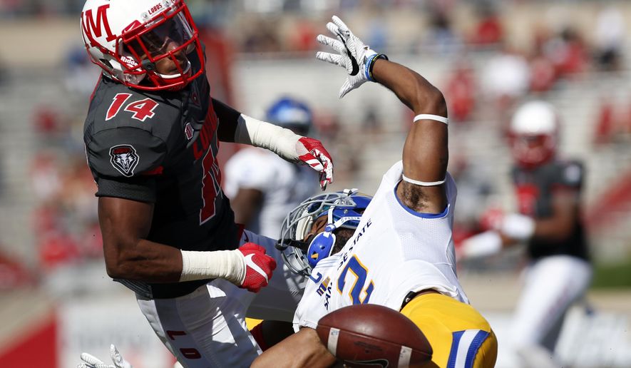 San Jose State wide receiver Tim Crawley (2) misses a reception near the end zone against the defense of New Mexico safety Daniel Henry during the first half of an NCAA college football game in Albuquerque, N.M., Saturday, Oct. 1, 2016. (AP Photo/Andres Leighton)