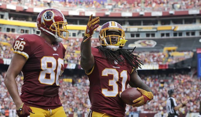 Washington Redskins tight end Jordan Reed (86) and running back Matt Jones (31) celebrate Jones&#x27; touchdown during the second half of an NFL football game against the Cleveland Browns, Sunday, Oct. 2, 2016, in Landover, Md. (AP Photo/Chuck Burton)