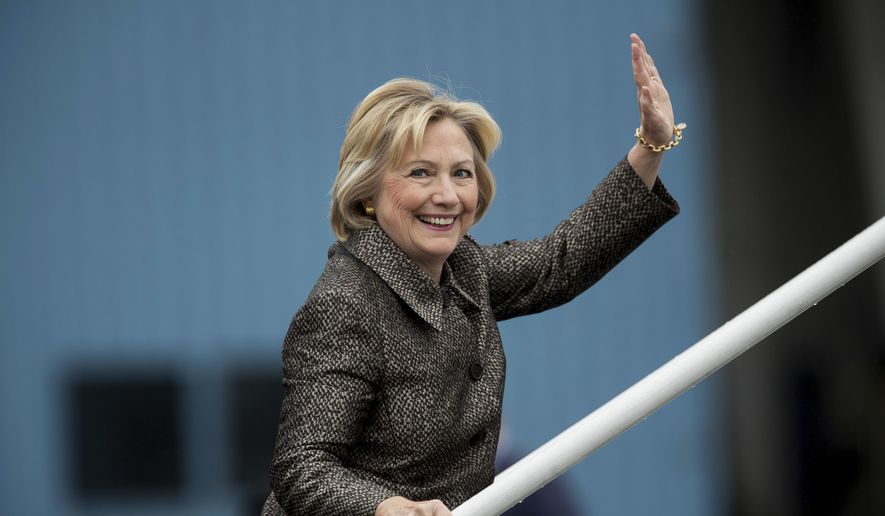 Democratic presidential candidate Hillary Clinton waves to members of the media as she boards her campaign plane in White Plains, N.Y., Sunday, Oct. 2, 2016, to travel to Charlotte Douglas International Airport. (AP Photo/Andrew Harnik)