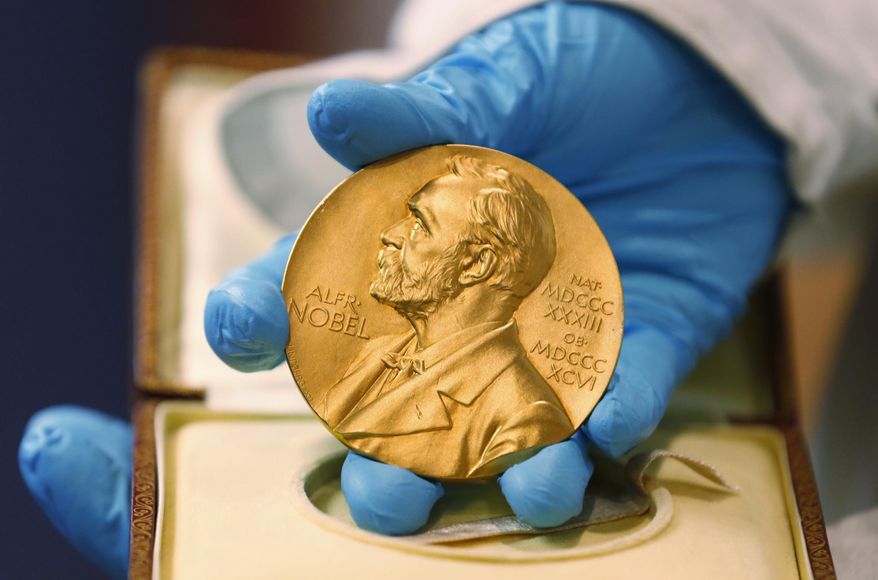In this file photo dated Friday, April 17, 2015, a national library employee shows the gold Nobel Prize medal awarded to the late novelist Gabriel Garcia Marquez, in Bogota, Colombia. There is no bigger international honor than the Nobel Prize, created by 19th-century Swedish industrialist Alfred Nobel, and the 2016 laureates will be named over the coming days to join the pantheon of greats who were honored in years gone by. (AP Photo/Fernando Vergara, FILE)