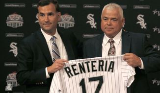 Chicago White Sox senior vice president and general manager Rick Hahn, left, poses with Rick Renteria after Hahn announced that Renteria will replace Robin Ventura as manager of the ball club during a baseball news conference Monday, Oct. 3, 2016, in Chicago. (AP Photo/Charles Rex Arbogast)
