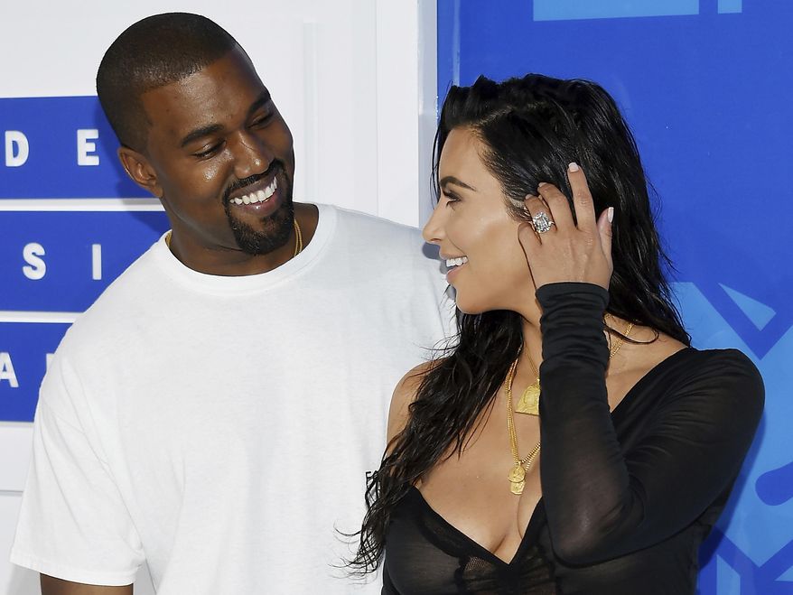 FILE - In this Aug. 28, 2016 file photo, Kanye West, left, and Kim Kardashian West arrive at the MTV Video Music Awards in New York. Armed robbers forced their way into a private Paris residence early Monday, Oct. 3, where Kim Kardashian West was staying and tied her up, police officials said. They said five assailants, who are still at large, stole a jewelry box containing valuables worth 6 million euros ($6.7 million) as well as a ring worth 4 million euros ($4.5 million.) (Photo by Evan Agostini/Invision/AP, File)