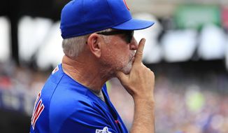 FILE - In this July 3, 2016, file photo, Chicago Cubs manager Joe Maddon looks on during the second inning of the baseball game against the New York Mets at Citi Field in New York. On the morning after the Cubs clinched a playoff spot, few members of the team with the best record in baseball had wandered back into the clubhouse ahead of an afternoon start still three hours away. Manager Joe Maddon, though, was already in his office and already focused on what mattered next _ breaking a century-and-counting World Series hex. (AP Photo/Seth Wenig, File)