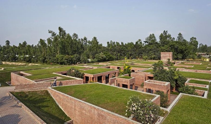 In this undated photo made available by Agha Khan Award for Architecture, people walk at the Friendship Centre in Gaibandha, Bangladesh which is one of the Agha khan award winning projects of 2016. The project is located in rural Gaibandha where agriculture is predominant, the project's roofscape merges with its environment. (AKTC via AP)