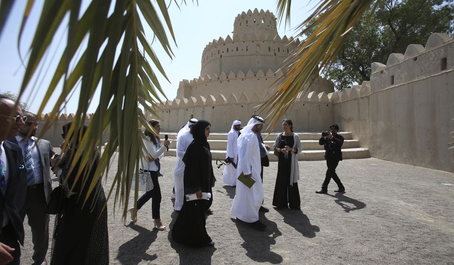 Emirati and the other officials walk at the historical Al Jahili Fort during the Aga Khan Award for Architecture announcement ceremony in Al Ain, United Arab Emirates, Monday, Oct. 3, 2016. A children’s center in China, a bridge in Iran and a park in Denmark are among the six winners of the Aga Khan Award for Architecture. The winners were announced Monday in the United Arab Emirates city of Al Ain. The awards are handed out once every three years and are meant to celebrate architecture that serves and embraces Muslim culture. (AP Photo/Kamran Jebreili)