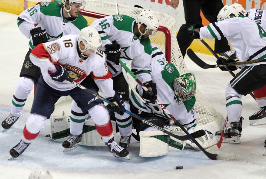 Florida Panthers' Aleksander Barkov (16) tries to control the puck in front of Dallas Stars goalie Maxime Lagace (35) as Stars' Ludwig Bystrom (36) and Gemel Smith defend during NHL hockey preseason action in London, Ontario, Sunday, Oct. 2, 2016. (Dave Chidley/The Canadian Press via AP)