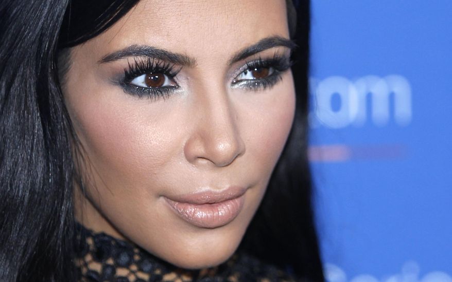 In this June 24, 2015, file photo, Kim Kardashian West poses during a photo call at the Cannes Lions 2015. A spokeswoman for Kardashian West says she was held up at gunpoint inside her Paris hotel room Sunday, Oct. 2, 2016, by two armed masked men dressed as police officers. The representative said the reality TV star is "badly shaken but physically unharmed." She offered no other details. (AP Photo/Lionel Cironneau, File)