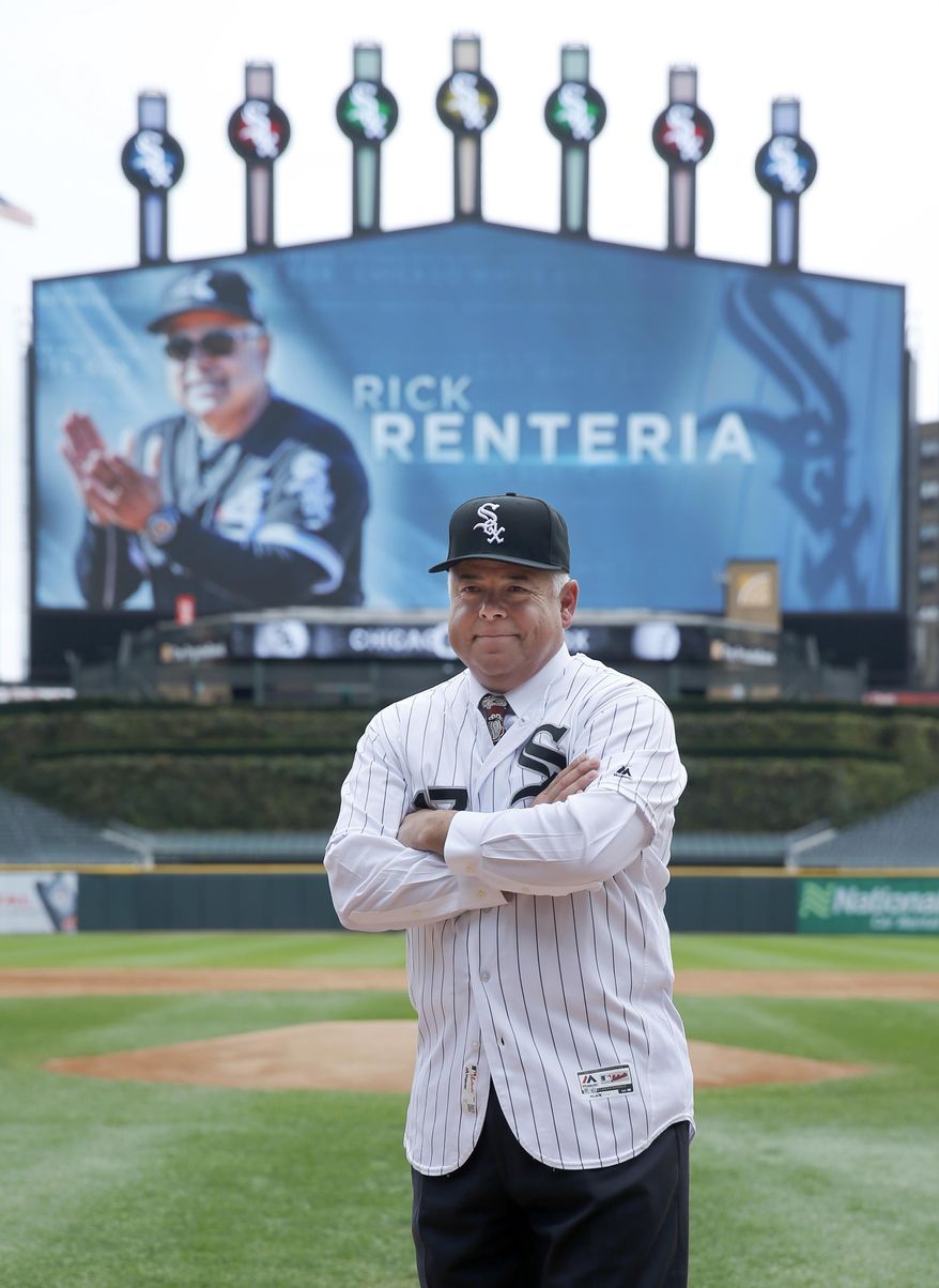 Chicago White Sox manager Rick Renteria poses at home plate after becoming the 40th manager of the team at a baseball news conference Monday, Oct. 3, 2016, in Chicago. (AP Photo/Charles Rex Arbogast)