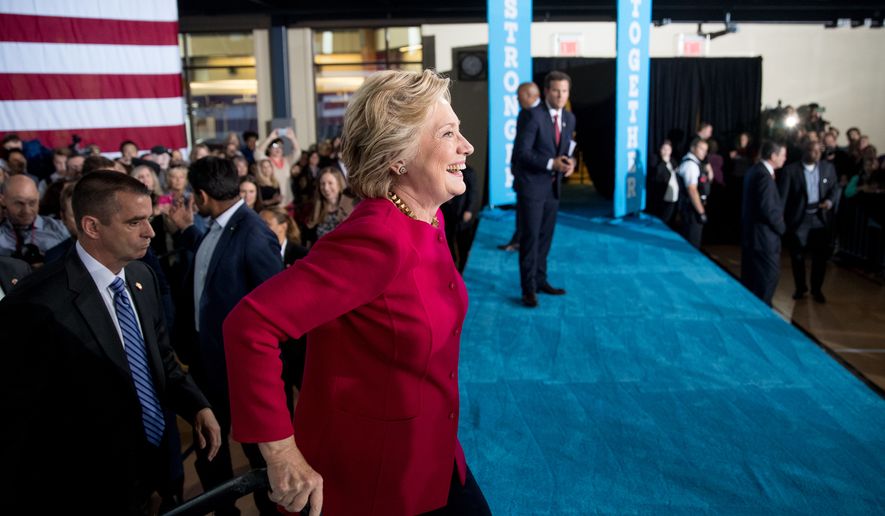 Democratic presidential candidate Hillary Clinton crosses the stage to greet members of the audience at a town hall at the Haverford Community Recreation and Environmental Center in Haverford, Pa., Tuesday, Oct. 4, 2016. (AP Photo/Andrew Harnik)