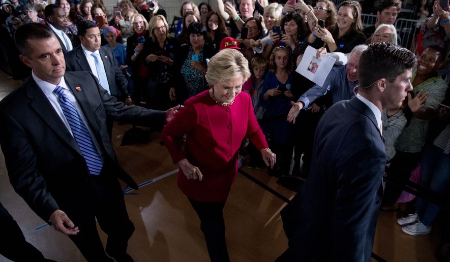 Democratic presidential candidate Hillary Clinton accompanied by members of the Secret Service, walks to greet members of the audience at a town hall at the Haverford Community Recreation and Environmental Center in Haverford, Pa., Tuesday, Oct. 4, 2016. (AP Photo/Andrew Harnik)