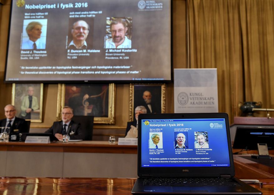 The Royal Academy of Sciences members, from left, Professor Nils Martensson, Professor Goran K Hansson and Professor Thomas Hans Hansson reveal the winners of the Nobel Prize in physics, at the Royal Swedish Academy of Sciences, in Stockholm, Sweden, Tuesday, Oct. 4, 2016. David Thouless, Duncan Haldane and Michael Kosterlitz have won the Nobel physics prize. Nobel jury praises physics winners for 'discoveries of topological phase transitions and topological phases of matter'. (Anders Wiklund /TT via AP)