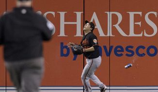 Baltimore Orioles&#39; Hyun Soo Kim gets under a fly ball as a can falls past him during the seventh inning of an American League wild-card baseball game against the Toronto Blue Jays in Toronto, Tuesday, Oct. 4, 2016. (Mark Blinch/The Canadian Press via AP)
