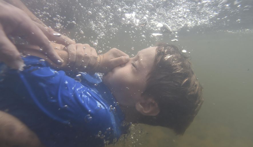 In this file photo, Garrett Dorsey, 8, is baptized in the Chattahoochee River, Sunday, Sept. 18, 2016, near Demorest, Ga. (AP Photo/Mike Stewart) **FILE**