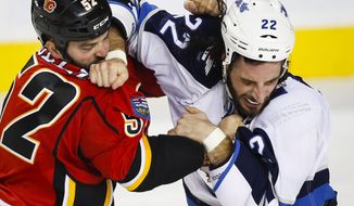 Winnipeg Jets&#39; Chris Thorburn, right, and Calgary Flames&#39; Brandon Bollig fight during the second period of a pre-season NHL hockey game in Calgary, Sunday, Oct. 2, 2016. (Jeff McIntosh/The Canadian Press via AP)