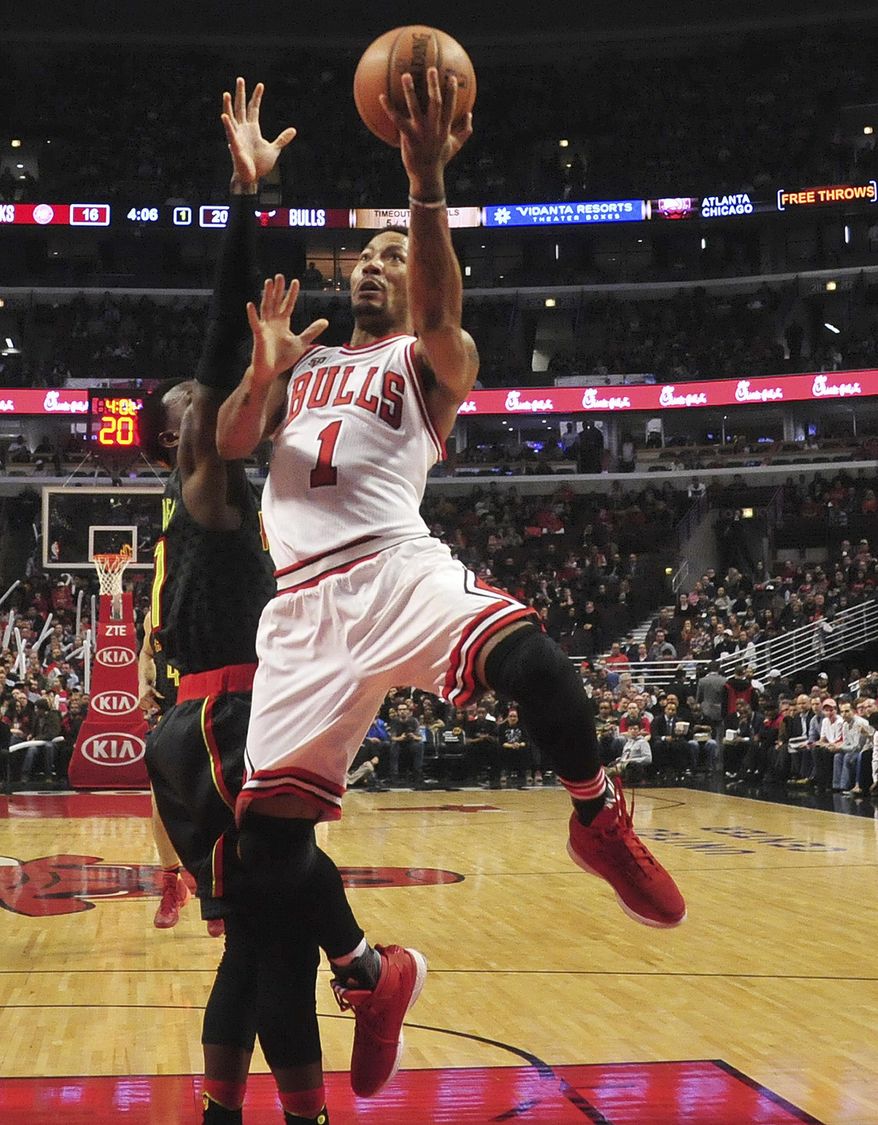 FILE - In this March 28, 2016, file photo, former Chicago Bulls guard Derrick Rose (1) goes to the basket on Atlanta Hawks guard Jeff Teague during the first half of an NBA basketball game in Chicago. The NBA star Rose is due in a Los Angeles courtroom Tuesday, Oct. 4, to fight a $21 million lawsuit by a former girlfriend who accuses him and two friends of gang raping her three years ago when she was incapacitated. The start of the trial in U.S. District Court conflicts with the Knicks preseason opener in Houston and it’s not clear which Rose will attend. (AP Photo/David Banks, File)