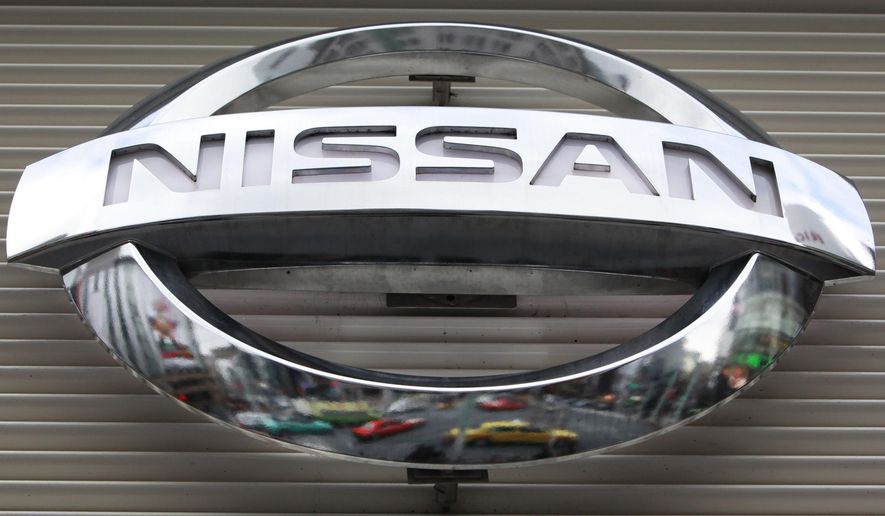 FILE - In this Wednesday, Feb. 8, 2012, file photo, vehicles are reflected on the logo of the Nissan Motors Co. at a showroom in Tokyo's Ginza shopping district. The government is investigating complaints that side air bags on some Nissan Versa small cars can inflate if the driver or passenger doors are slammed too hard. The National Highway Traffic Safety Administration said Tuesday, Oct. 4, 2016, that the probe covers about 155,000 cars from the 2012 model year. (AP Photo/Shizuo Kambayashi, File)