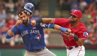 FILE - In this May 15, 2016, file photo, Toronto Blue Jays&#39; Jose Bautista, left, is hit by Texas Rangers second baseman Rougned Odor, right, after Bautista slid into second in the eighth inning of a baseball game at Globe Life Park in Arlington, Texas. The Rangers and Blue Jays meet in an ALDS rematch. Game 1 is Thursday, Oct. 6. (Richard W. Rodriguez/Star-Telegram via AP, File)