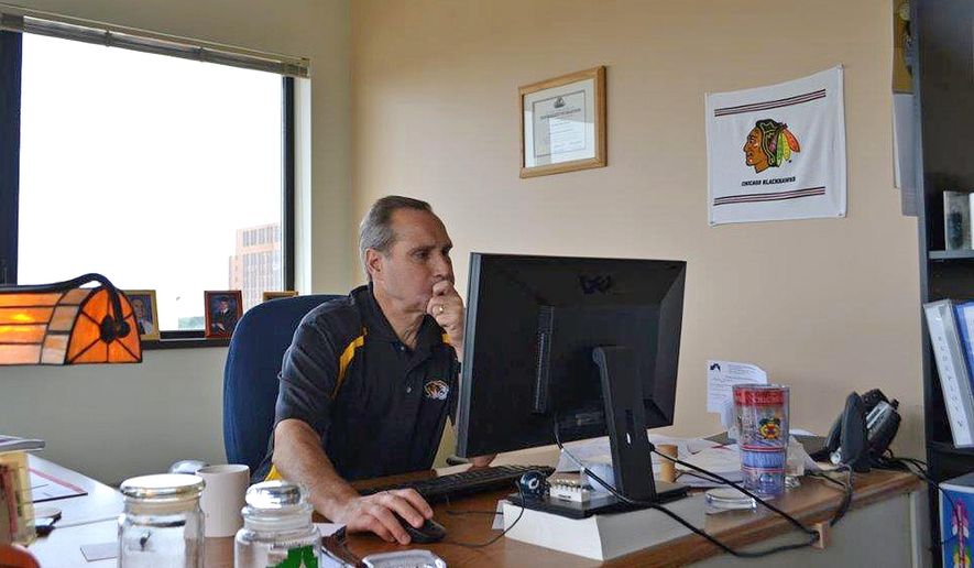 In this Sept. 19, 2016 photo, Randy Macak works in his office at the Law and  Justice Center in Bloomington, Ill. Macak sees the scope of problems enforcing juvenile justice as Director of juvenile court services in Mclean County. In his three decades working in juvenile probation services, he has developed his own system for measuring the success of youth who have contact, brief or extended, with the criminal justice system.(Edith Brady-Lunny,/The Pantagraph via AP)
