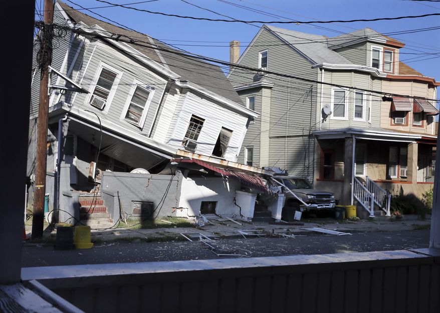 A heavily damaged duplex home is seen after an explosion Wednesday, Oct. 5, 2016, in Trenton, N.J. Authorities say an apparent explosion damaged the duplex home, but it's not yet clear what caused the blast. Authorities say two people were taken to a hospital for evaluations, but further details on their conditions were not immediately available. The blast came one day after a similar incident in Paterson, N.J. Two multifamily houses were destroyed in that explosion, which officials say may have been caused by a gas leak. (AP Photo/Mel Evans)