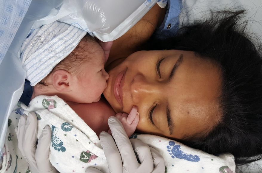 This Sept. 4, 2016 photo provided by Ryan Grassley shows Lidia Grassley and her son Samuel at Utah Valley Hospital in Provo, Utah. Ryan Grassley discovered a perplexing charge on a hospital bill for the recent birth of his son. Nearly $40 for "skin to skin" contact after his wife gave birth via cesarean section.Amused by the bill, he posted a picture of it on Reddit this week and commented: "I had to pay $39.35 to hold my baby after he was born." The post set off a flurry of outrage and consternation on Reddit with many people sharing their own stories of bizarre medical charges. A hospital spokeswoman said the fee wasn't for Grassley to hold his baby, but to have an additional nurse in the room for the c-section to ensure mom and baby were safe. (Ryan Grassley via AP)