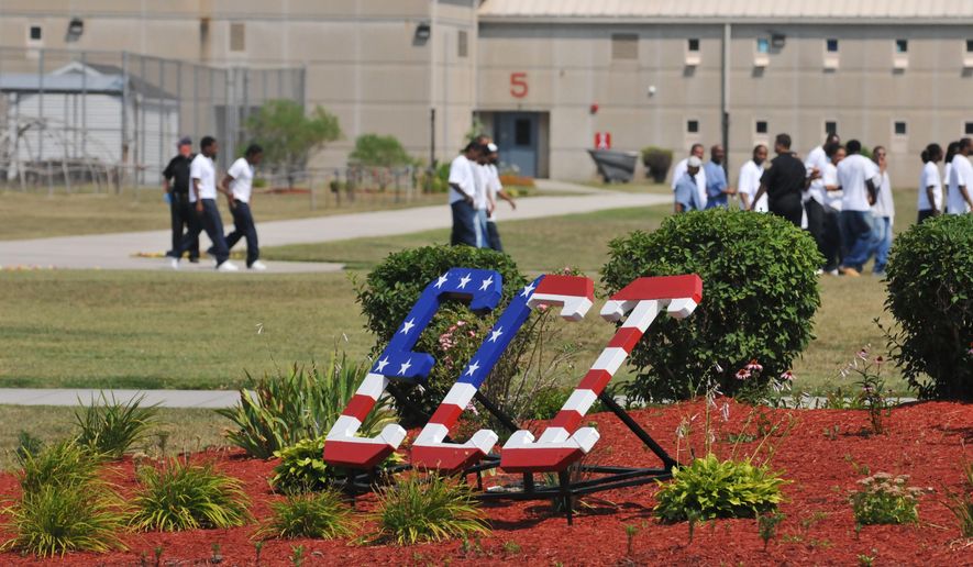In this 2012 photo, correctional officers watch inmates as they walk the yard of the Eastern Correctional Institution in Westover, M.D. Correctional officers at Maryland’s largest state prison for years helped scores of inmates smuggle narcotics, tobacco, pornography and cellphones into the facility in exchange for money and sex, according to a pair of sweeping federal indictments unsealed Wednesday, Oct. 5, 2016. (Todd Dudek/The Daily Times via AP)