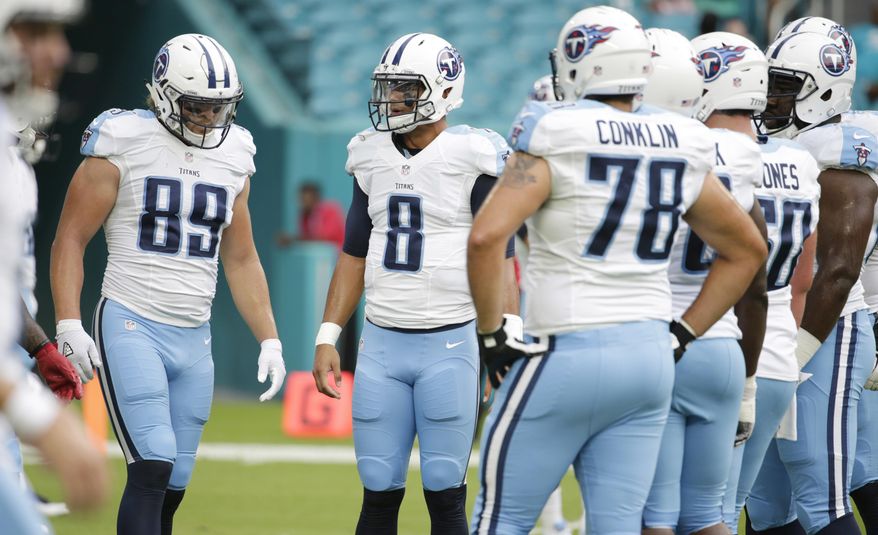 FILE - In this Sept. 1, 2016, file photo, Tennessee Titans quarterback Marcus Mariota (8) talks to the offensive line before an NFL preseason game against the Miami Dolphins, in Miami Gardens, Fla. The Titans are doing one thing better so far this season in protecting Mariota. They'll get another big test Sunday from the Miami Dolphins, who knocked the quarterback out with a sprained knee a year ago. (AP Photo/Lynne Sladky, File)