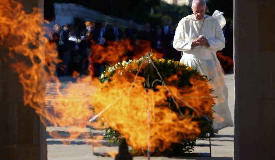 Pope Francis prays in front of the monument to the fallen for the independence, in Ganjlik, Azerbaijan October 2, 2016. Francis traveled to Azerbaijan on Sunday for a 10-hour visit aimed at encouraging the country&#39;s inter-religious harmony while likely overlooking criticism of a referendum that extends the president&#39;s term and powers. (Alessandro Bianchi/Pool Photo via AP)