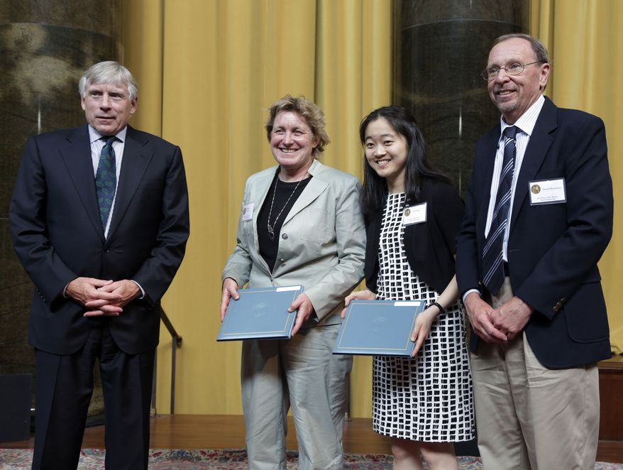 Columbia University President Lee Bollinger (left) poses with Elizabeth McGowan, Lisa Song and David Hasemyer of InsideClimate News — winners of the 2013 Pulitzer Prize for National Reporting — during the award ceremony at Columbia University's Law Library on May 30, 2013, in New York. (Associated Press)