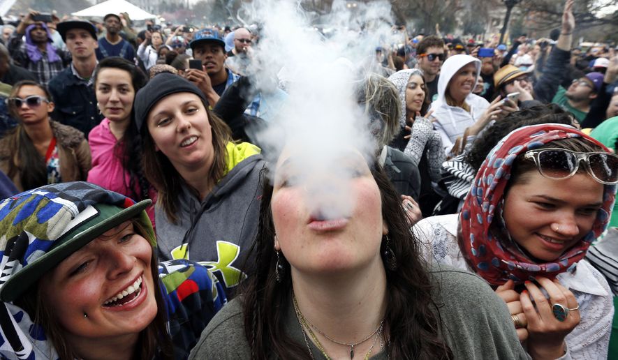 Partygoers dance and smoke pot at the annual 4/20 marijuana festival in Denver on April 19, 2014. (Associated Press)