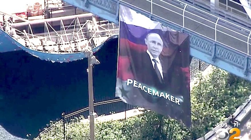 A giant 20-by-30-foot flag of Russian President Vladimir Putin was unfurled on the Manhattan Bridge on Thursday, Oct. 6, 2016. (WCBS 2 New York screenshot)